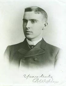 A very, very old picture of a young white man in a double-breasted suit and a flat-top haircut