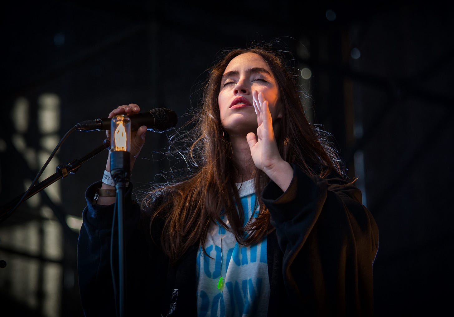 image of a singer on stage with her eyes closed, for article titled “The 7 Maxims of Creative Work” by Larry G. Maguire