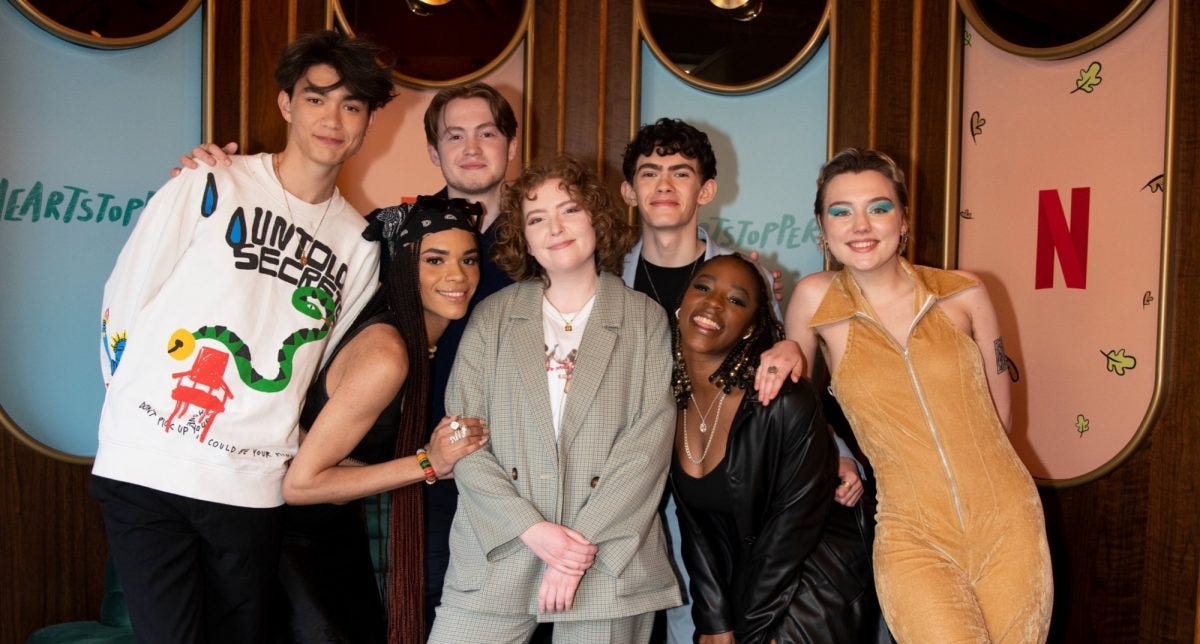 A picture of the Heartstopper cast and the creator of the comics, Alice Oseman.