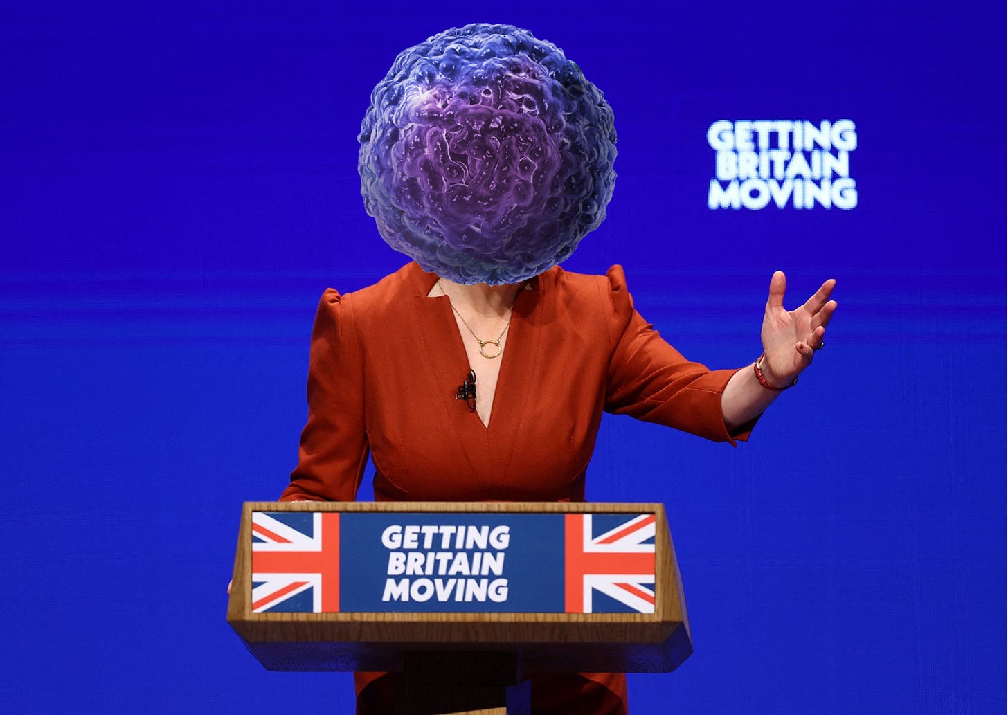 Liz Truss speaking at the Conservative Party Conference, her face replaced by a tumour