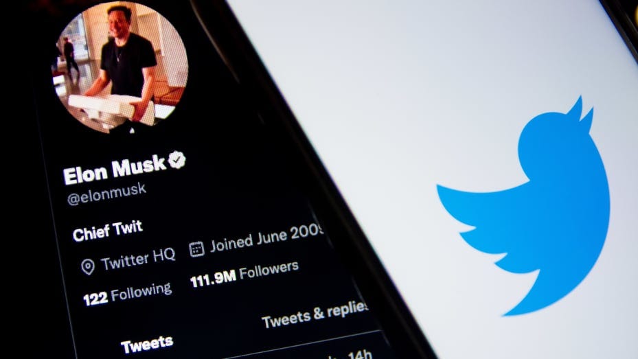 In this photo illustration a Twitter logo seen displayed on a smartphone screen with Elon Musk Twitter in the background in Athens, Greece on October 30, 2022. Elon Musk begins his Twitter ownership with firings.