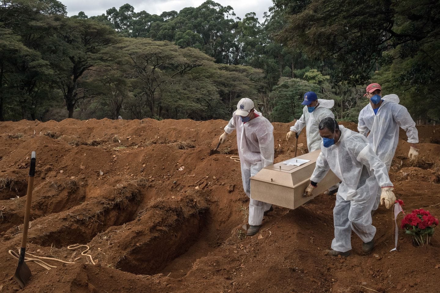 Gravediggers carried the coffin of a COVID-19 victim during a burial at Vila Formosa cemetery in São Paulo. The world’s known coronavirus death toll passed four million on Thursday, a loss roughly equivalent to the population of Los Angeles, according to the Center for Systems Science and Engineering at Johns Hopkins University.