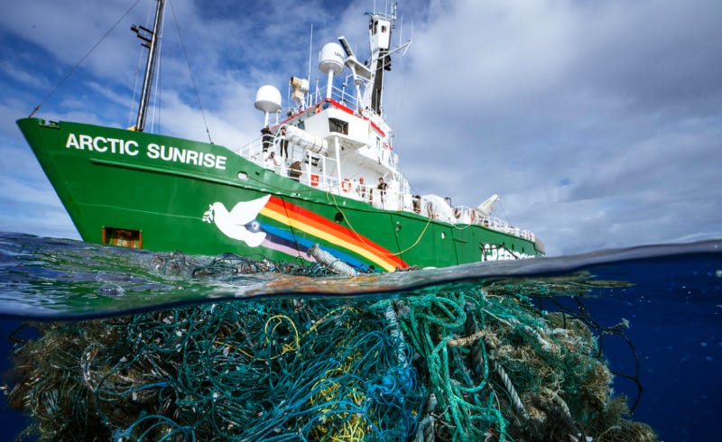 A Greenpeace boat, stuck in ocean garbage.