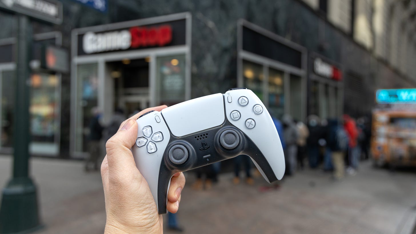 PS5 restock GameStop store with controller in hand