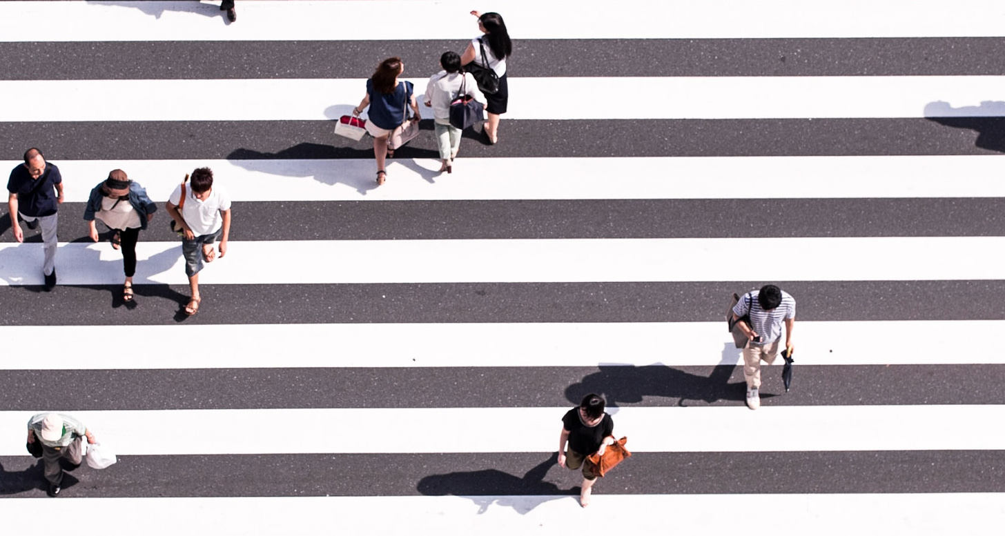 Overhead image of people crossing at a large pedestrian crossing
