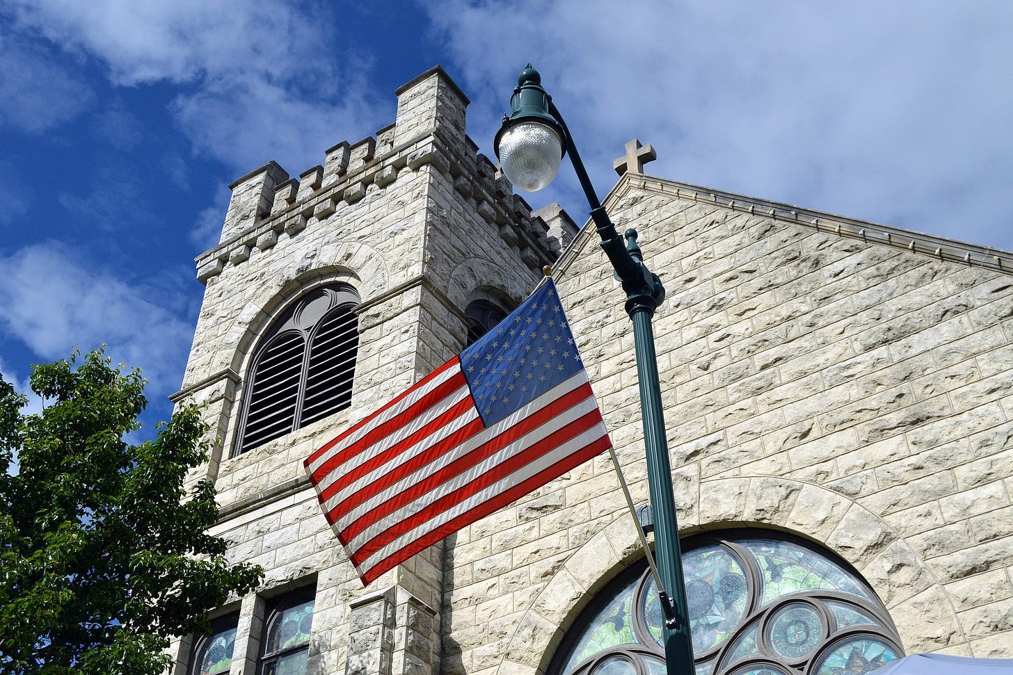 Picture of church with U.S. flag flying in front of it.