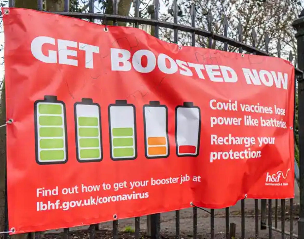 Poster in the UK hung on a fence with drawings of batteries, some full and some low and the sign says Get boosted now. covid vaccines lose power like batteries. Recharge your protection. Find out how to get your booster jab at  lbhf.gov.uk/coronavirus 