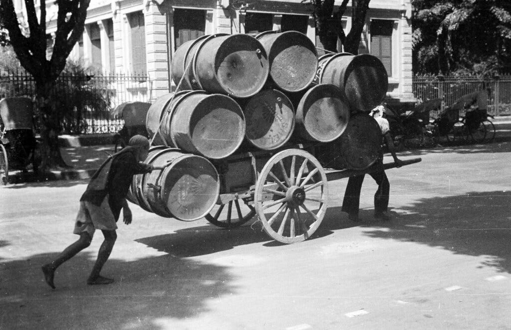 HANOI 1940 - Carting petroleum barrels through city street