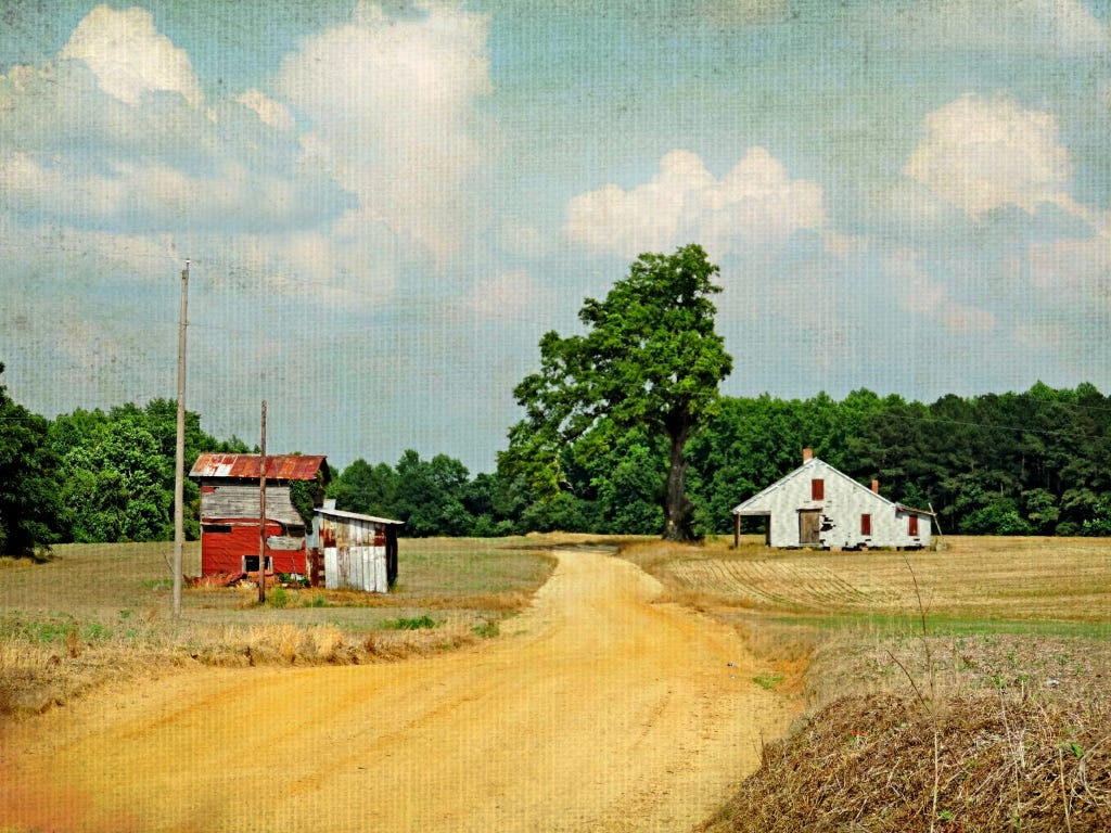 A photo of aged painting of a rural clay road in North Carolina with b red barn on the left and white shack on the right