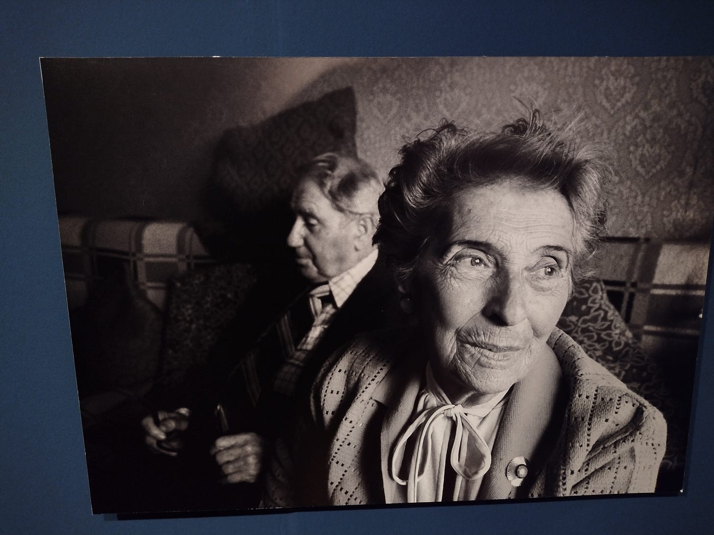 Image of Old Woman with Man in background