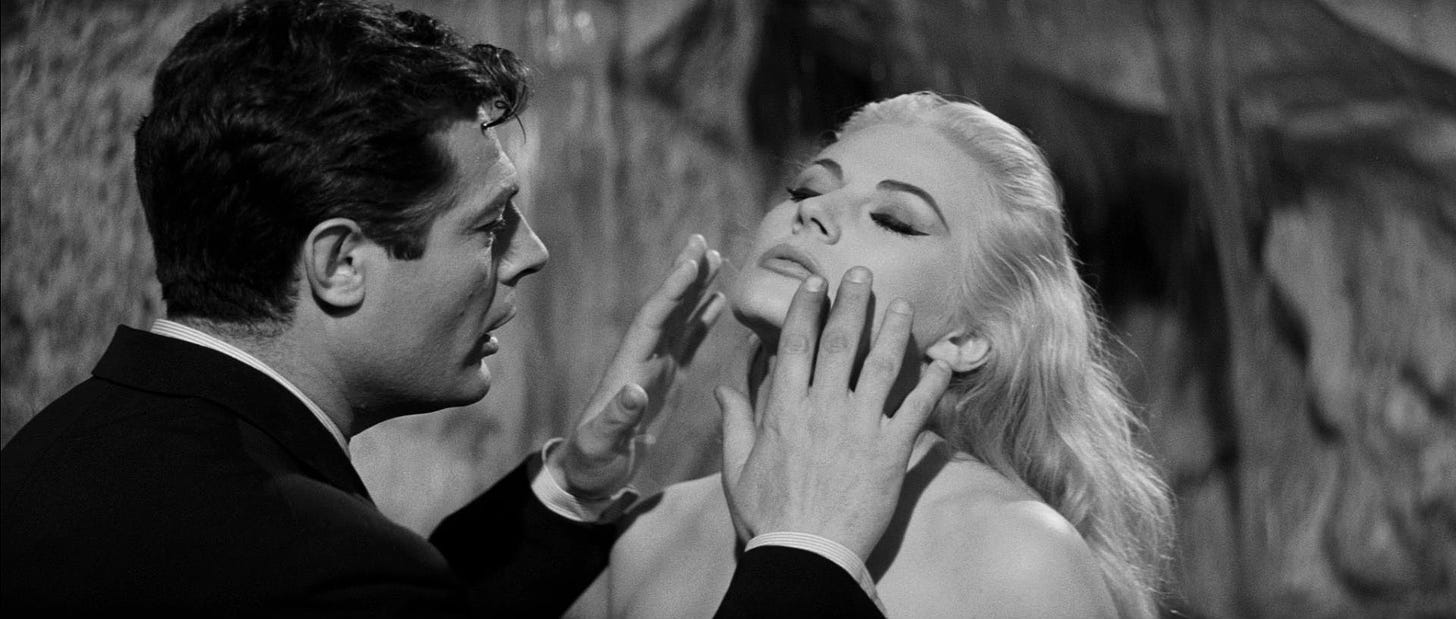 Marcello Mastroianni putting his hands out to touch Anita Ekberg’s face in Fellini’s “La Dolce Vita” (1960)