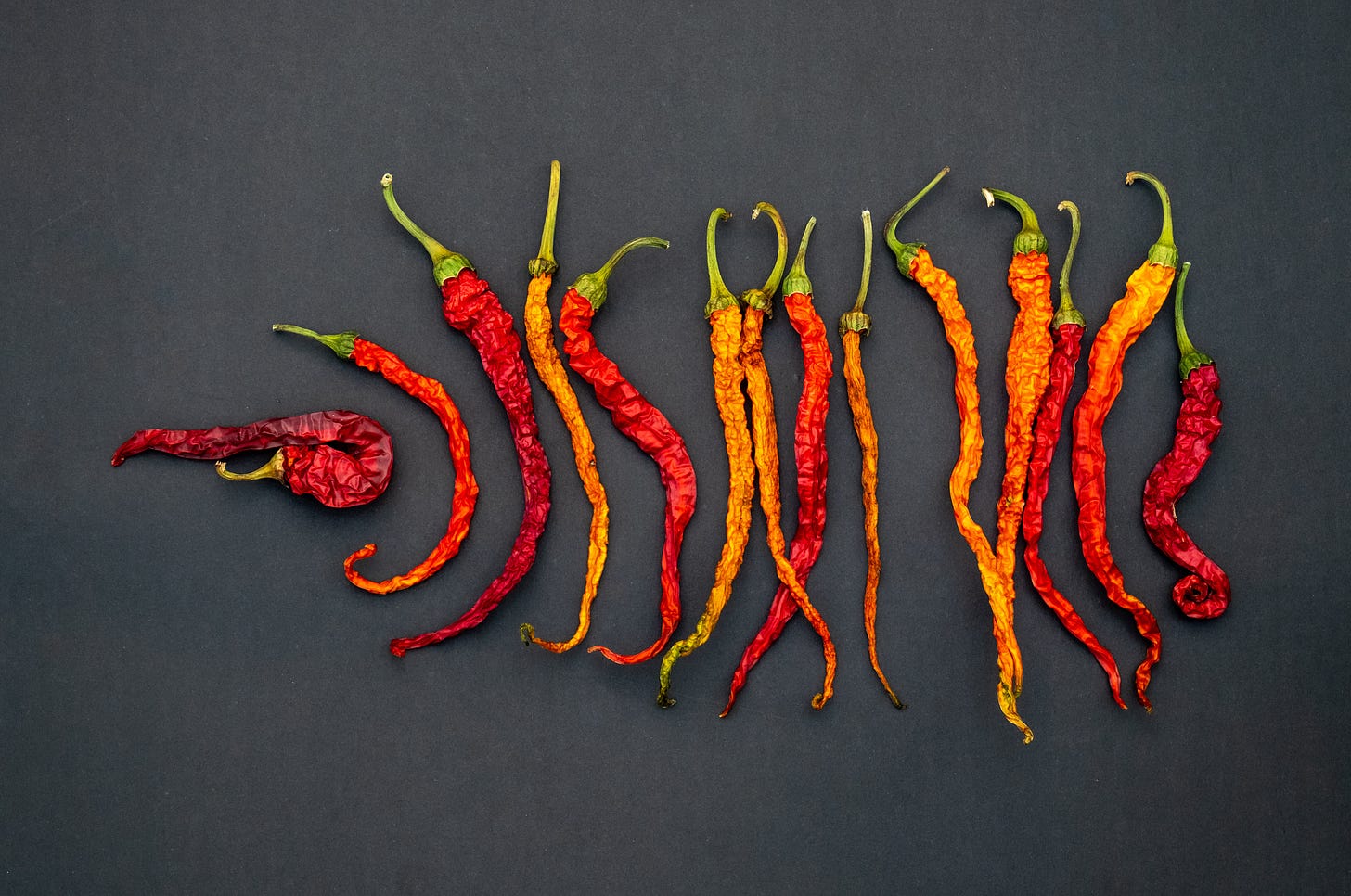 Spicy peppers arranged in a line.