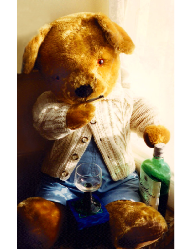 Staged photo of Merrythought bear holding a cigarette, with a glass of gin at its side.