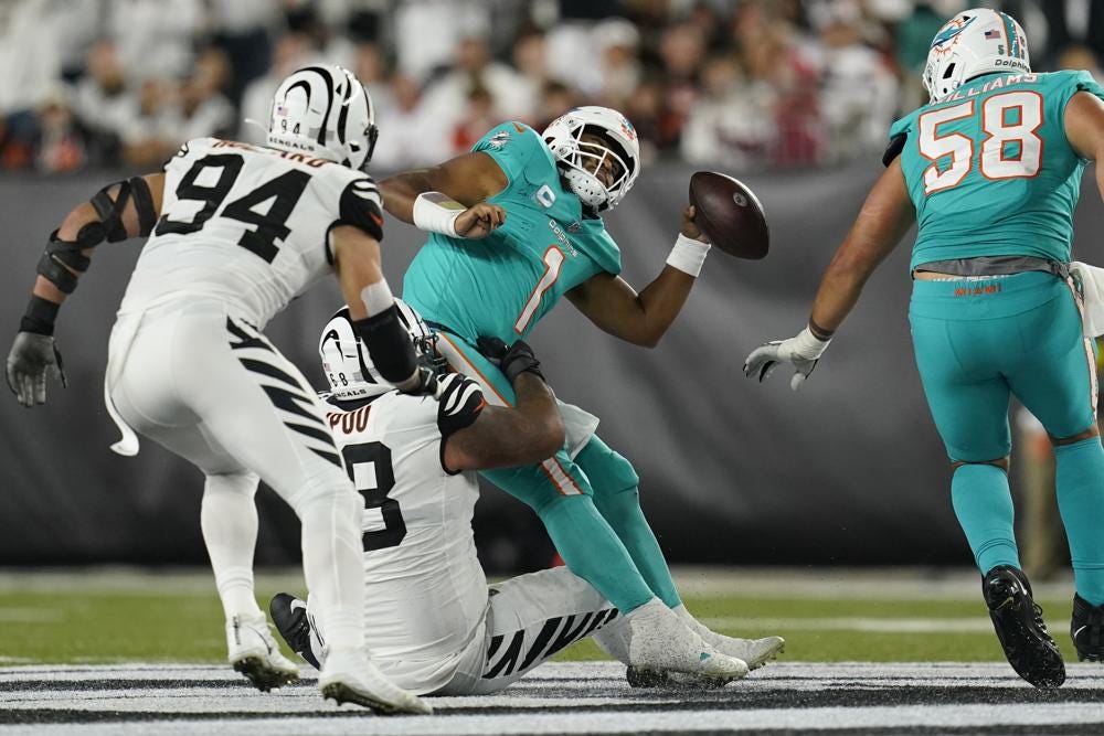 Miami Dolphins quarterback Tua Tagovailoa (1) is sacked by Cincinnati Bengals' Josh Tupou (68) during the first half of an NFL football game, Thursday, Sept. 29, 2022, in Cincinnati. (AP Photo/Joshua A. Bickel)