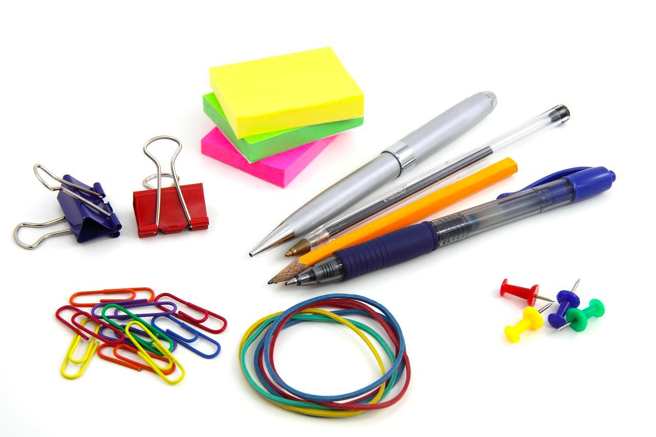 paperclips, rubber bands, writing utensils, clips, sticky notes, thumbtacks