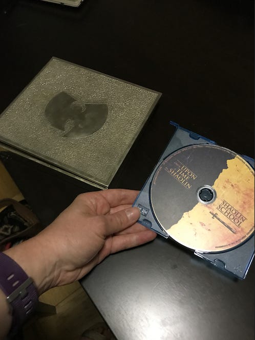 A photo of me holding the Wu-Tang album, which i posted on Twitter in 2017.