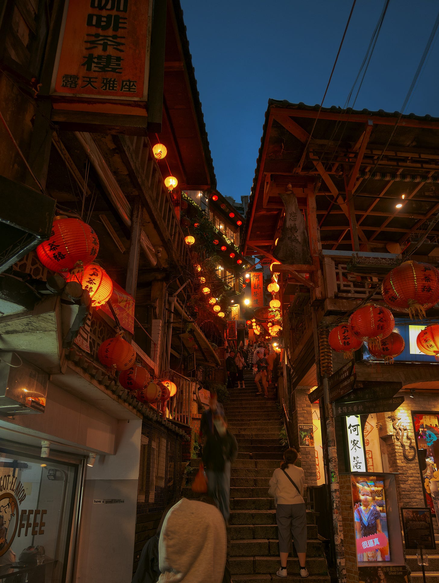 A steep, narrow staircase alley near Jiufen’s Amei Teahouse and Shengping Theater, lit with the town’s iconic red lanterns