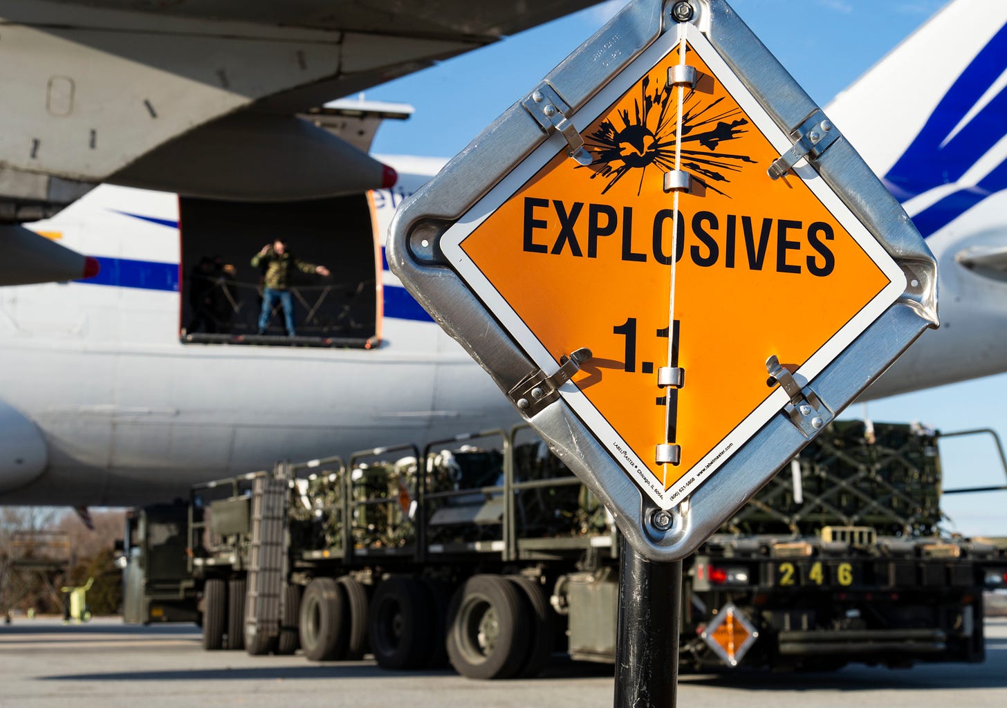 The US Air Force loads military cargo bound for Ukraine onto a plane in Delaware. In front is a sign that reads "explosives".