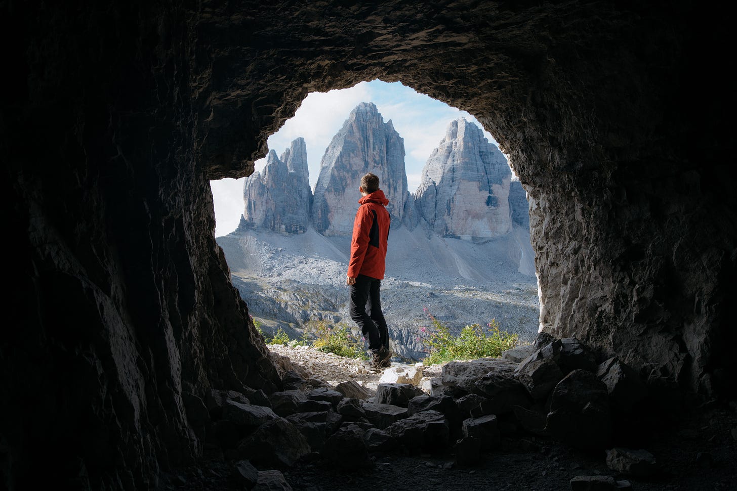 A man looking off at the mountains in the distance.