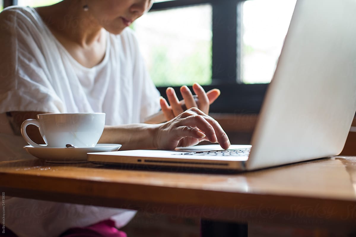 One Senior Asian Woman Working With Laptop In Cafe by Bo Bo - Business