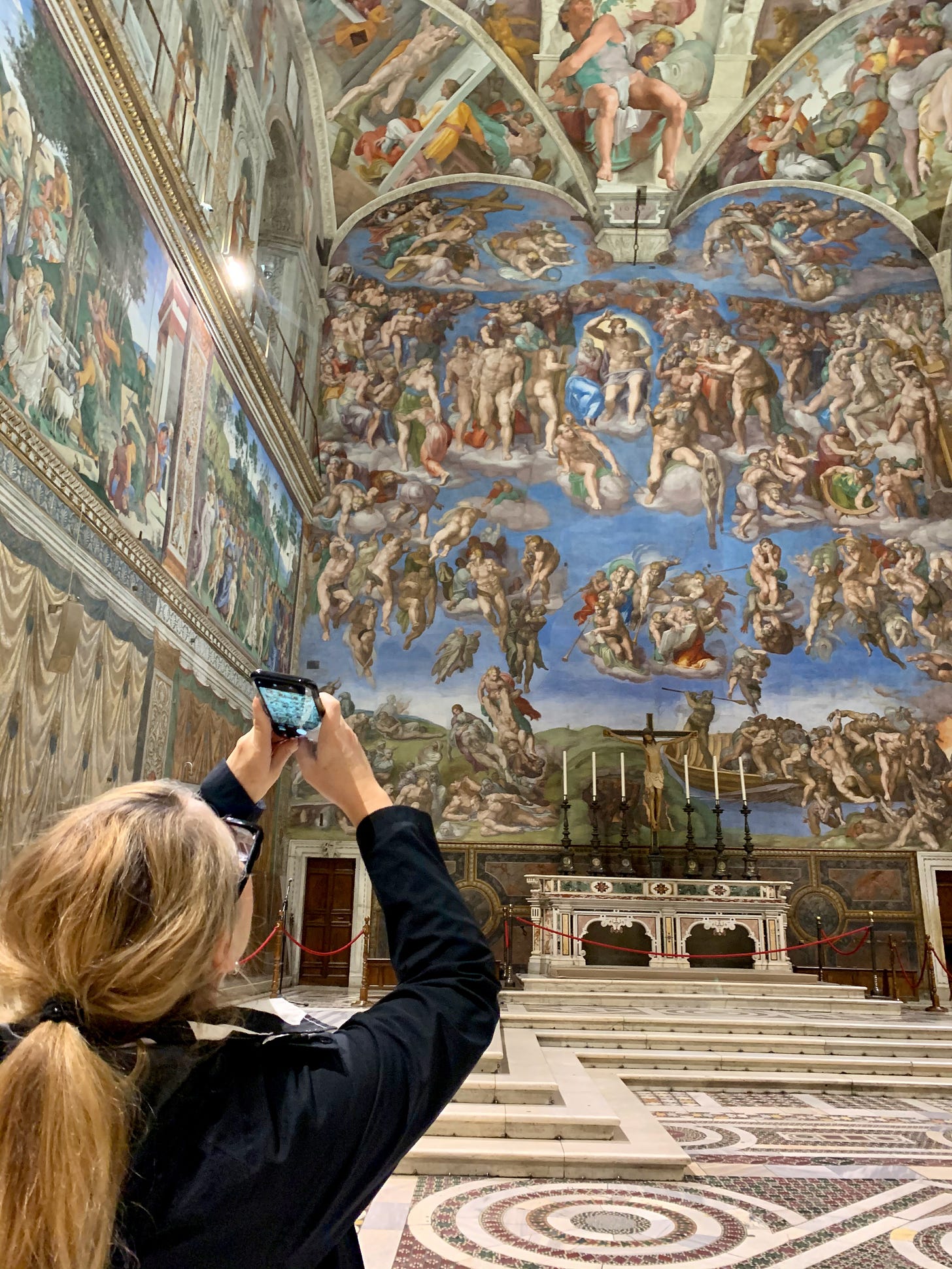Gillian taking a picture of the Last Judgement in an empty Sistine Chapel