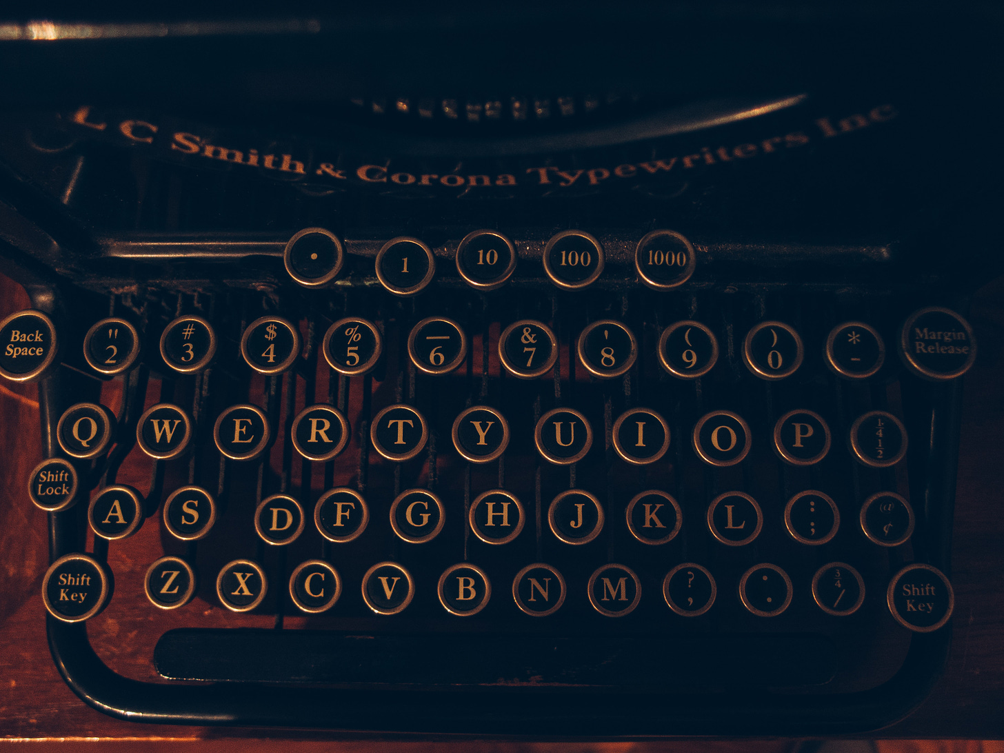 a dimly lit dramtic photo of an old typewriter keyboard