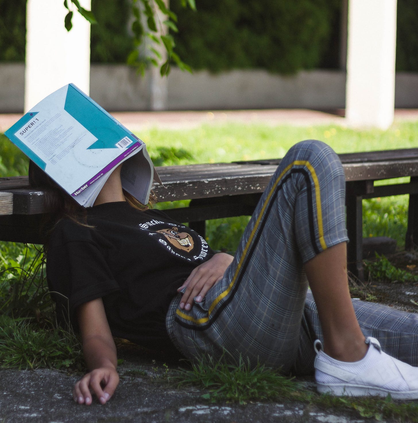 Man laying with book on face