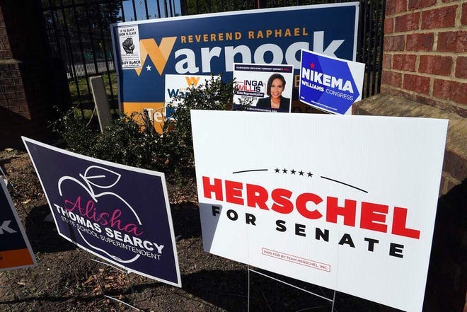 Signs are pictured outside of a polling station at C.T. Martin Natatorium and Recreation Center during the US midterm election, in Atlanta, Georgia on November 8, 2022.