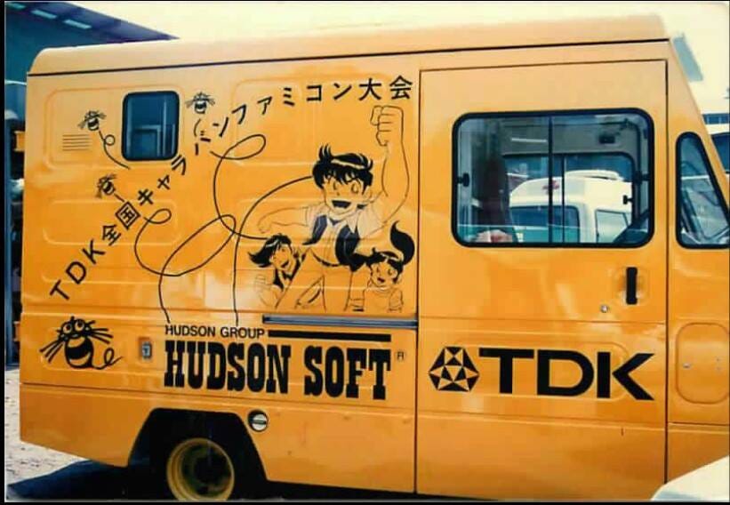 A photo of Hudson's yellow Caravan Festival bus, with the Hudson bee and logo all over it.