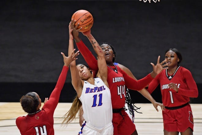 DePaul's Sonya Morris (11) and Louisville's Olivia Cochran (44) reach for a rebound Friday, Dec. 4, 2020, in Uncasville, Conn.