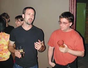 2 guys talking at a house party