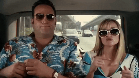 GIF: Vince Vaugn and Reese Witherspoon, in vacation garb, dance in the back of a cab