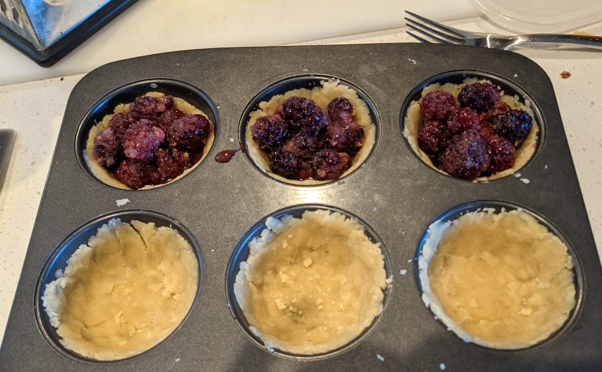 Six partially constructed pies.