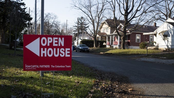 An "Open House" sign is displayed in the front yard of a home for sale in Columbus, Ohio.