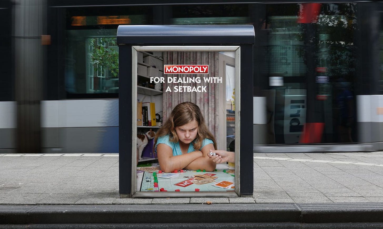 Picture features a grumpy looking child, hunched over a Monopoly board, with the headline "For dealing with a setback"