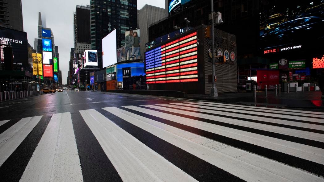 Times Square, which is usually very crowded on a weekday morning, is mostly empty Monday, March 23, 2020 in New York. Gov. Andrew Cuomo has ordered most New Yorkers to stay home from work to slow the coronavirus pandemic. (AP Photo/Mark Lennihan)