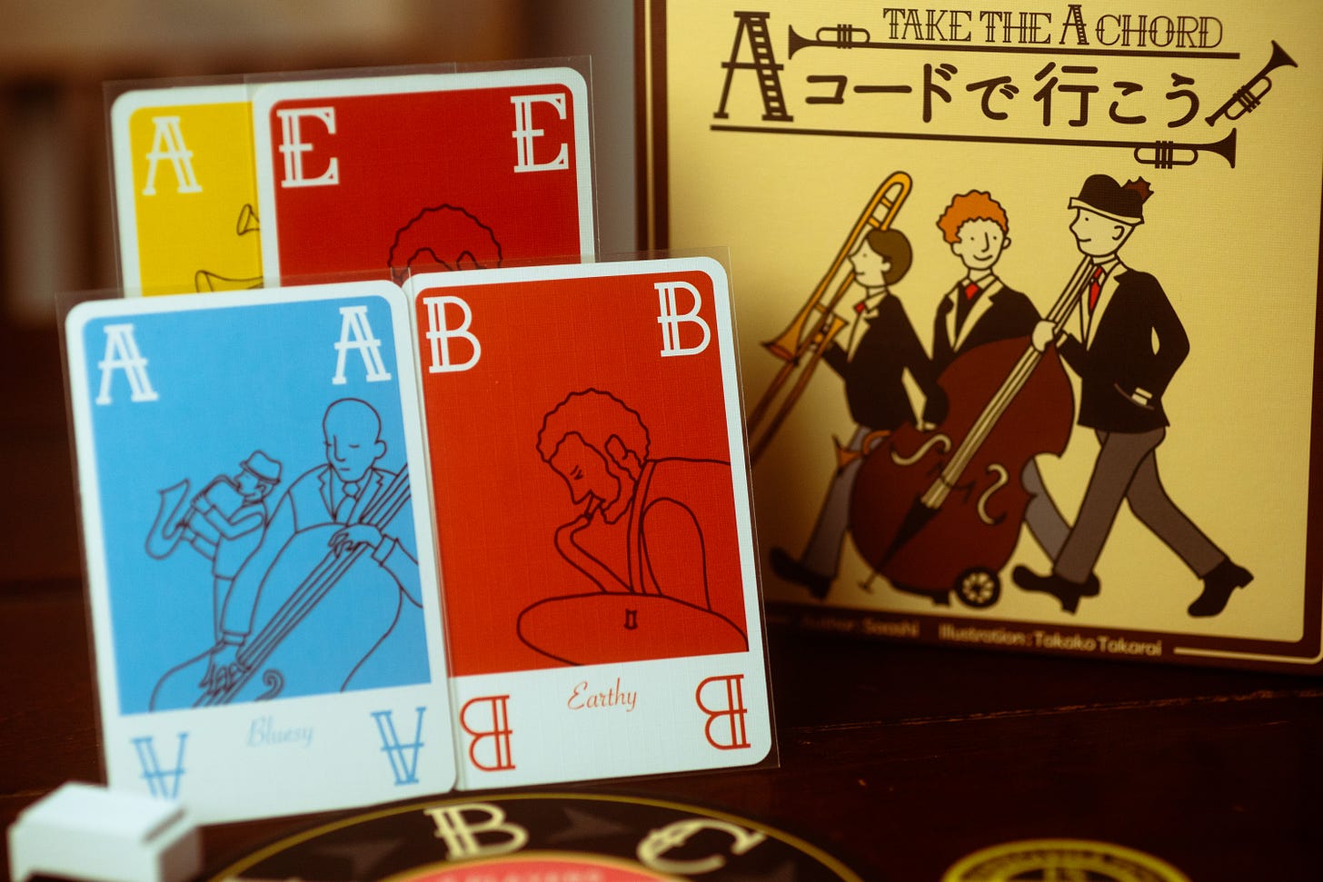 The card game Take the A Chord on display on a table. Several cards are visible of various suits.