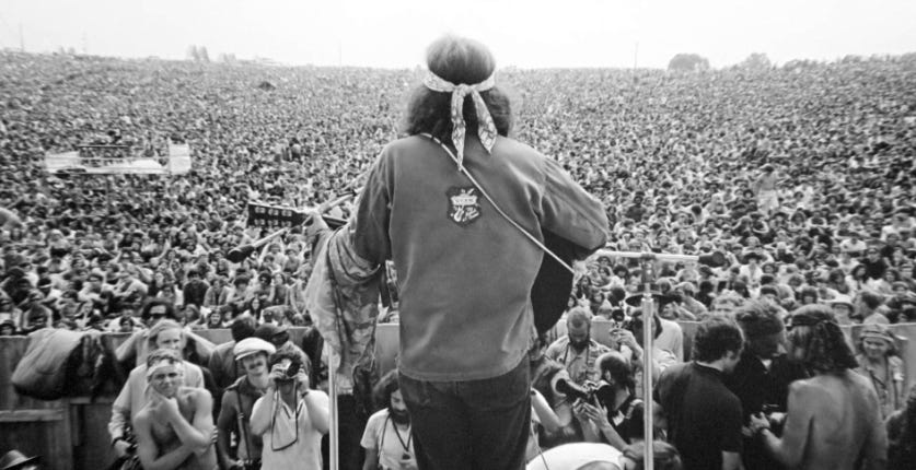 Country Joe and huge crowd at Woodstock Festival, 1969