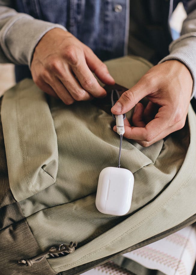 Lanyard loop attached to a backpack on the all-new charging case of the second-generation AirPods Pro.