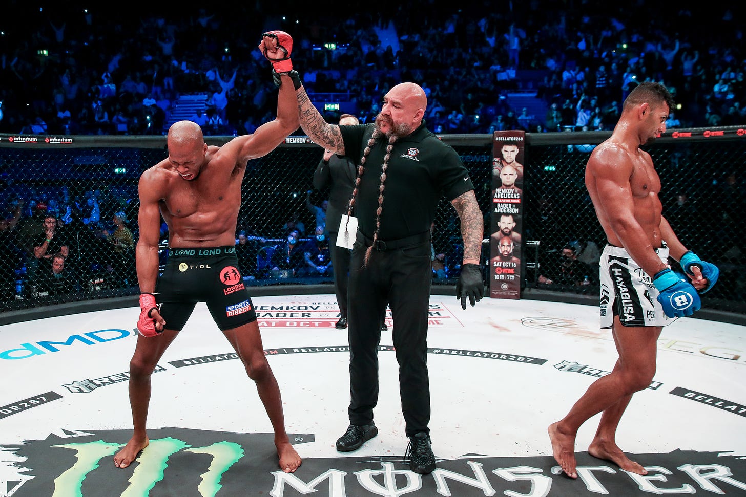 Michael Page gets his arm raised by a referee while Douglas Lima walks away in shock.