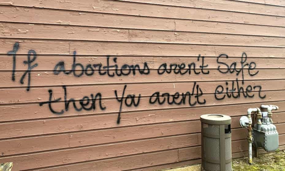 Threatening graffiti is seen on the exterior of Wisconsin Family Action offices in Madison, Wisconsin, on Sunday.