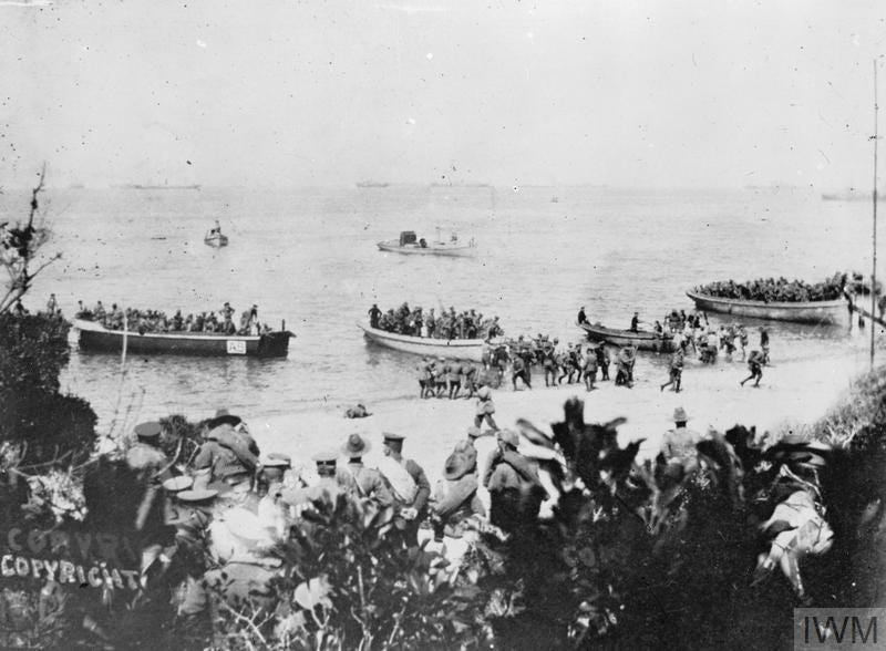 Australians landing at Anzac Cove at 8am, 25 April 1915 - part of the 4th Battalion and the mules for the 26th (Jacob's) Indian Mountain Battery. In the foreground is the staff of Colonel H N MacLaurin of the 1st Infantry Brigade. The officer with the rolled greatcoat over his shoulder is Major F D Irvine (killed on 27 April). Nearer the water's edge (centre) is Captain D M King, Orderly Officer. The officer on the left, with his chinstrap down, is Lieutenant R G Hamilton, the Brigade Signal Officer. 