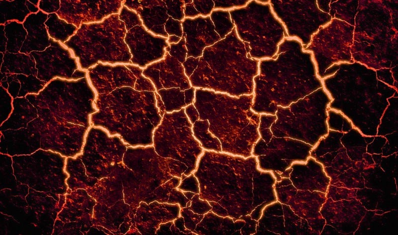 Glowing magma filled cracks in lava.