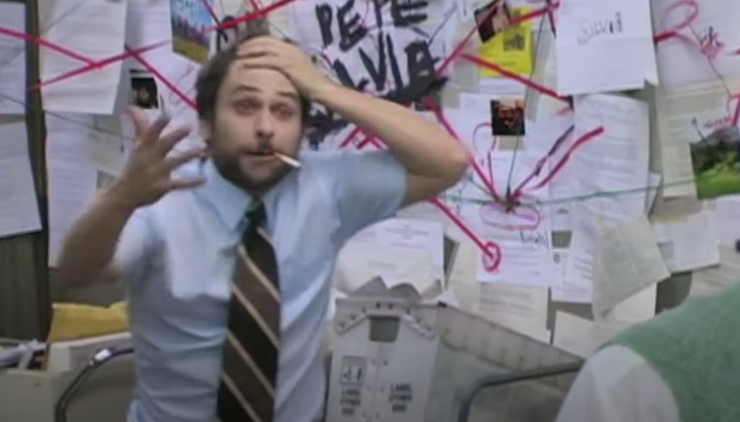 Screenshot from It's Always Sunny in Philadelphia of Charlie with his hand on his head looking confused and a wall of mail he has tacked up and connected with red string and the name, "Pepe Silvia" scribbled over it all in black is behind him. ©FX Networks
