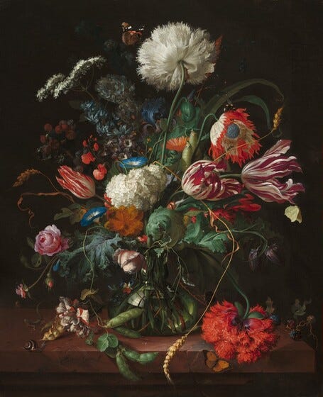 still life of flowers and greenery on a black background