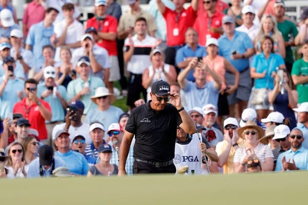 Phil Mickelson led Brooks Koepka by one shot and Louis Oosthuizen by two when he walked off the 18th green.