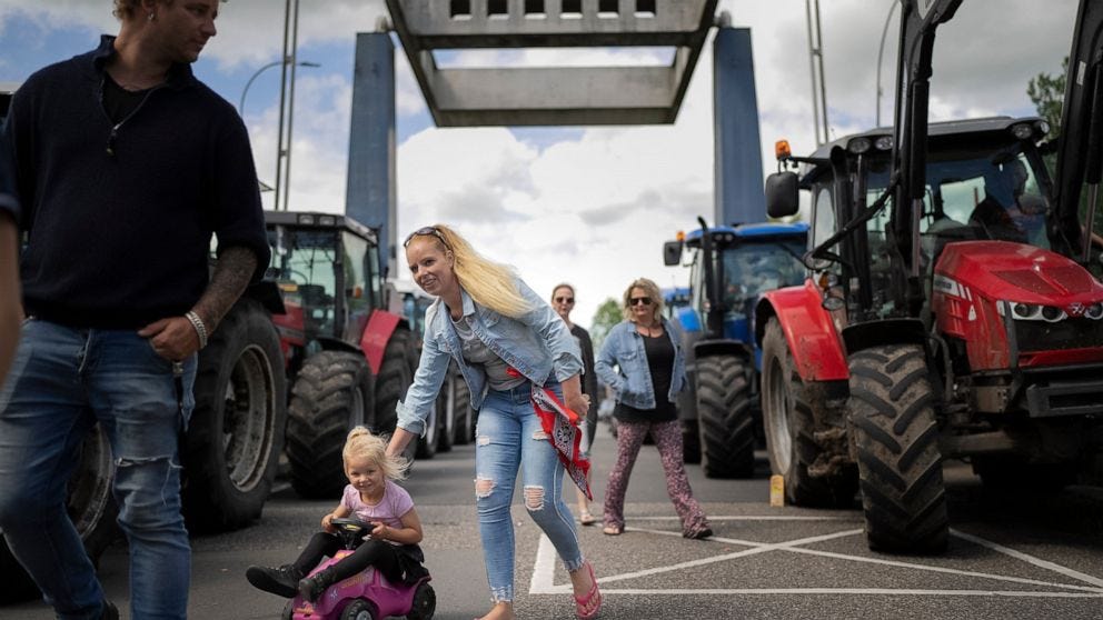 Protesting farmers block a drawbridge at locks in the Princess Margriet canal, preventing all ship traffic from passing in Gaarkeuken, northern Netherlands, Monday, July 4, 2022. Dutch farmers angry at government plans to slash emissions also used tr