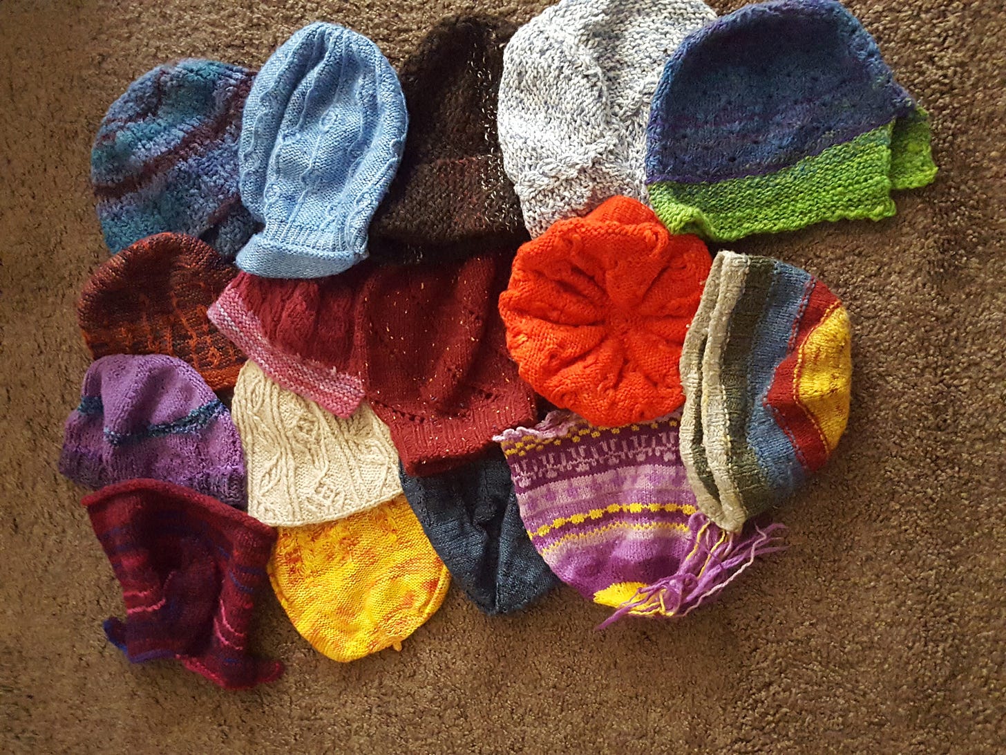 A pile of handknit hats showing abundance.