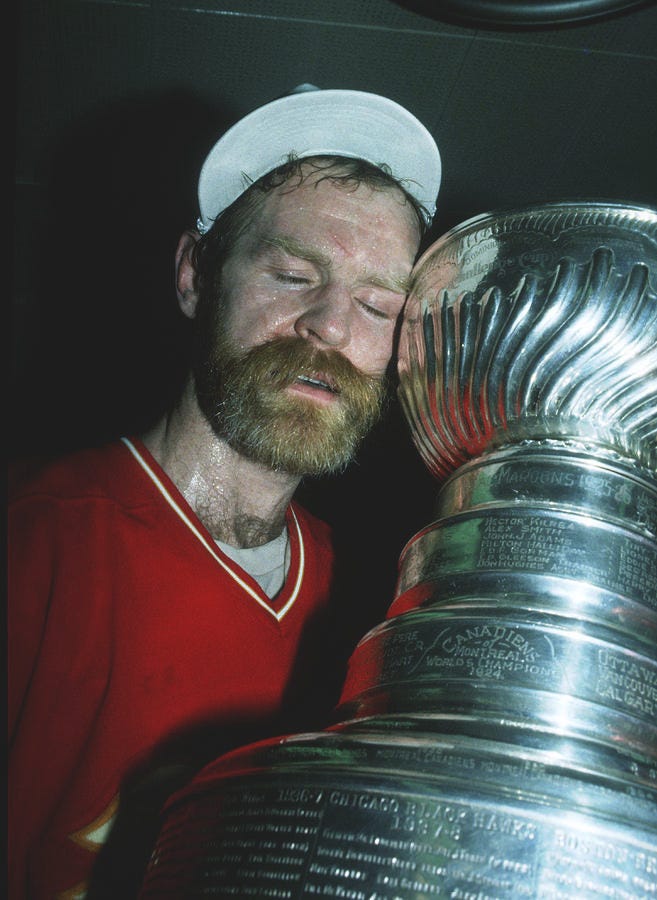 Lanny Mcdonald Hugs The Stanley Cup by B Bennett