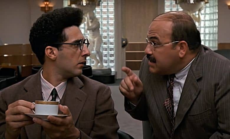 Screen shot of Barton Fink drinking coffee in an office